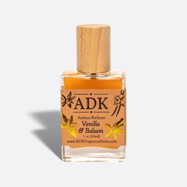 Vanilla Balsam perfume bottle. Designed with ADK logo and gold floral design.